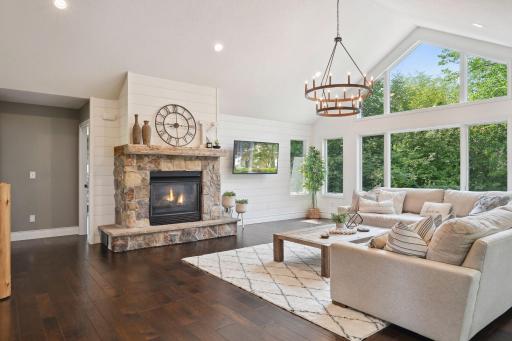 The stone surround fireplace adds a touch of cozy to this feature wall