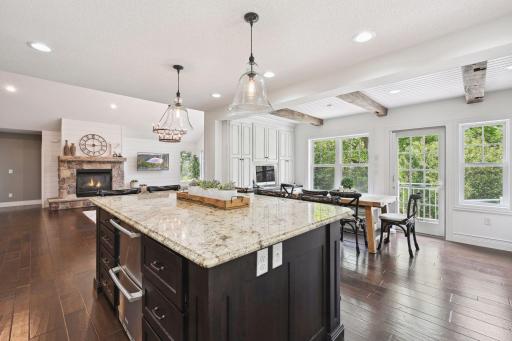 Kitchen flows into dining room, office nook, and walkout to patio