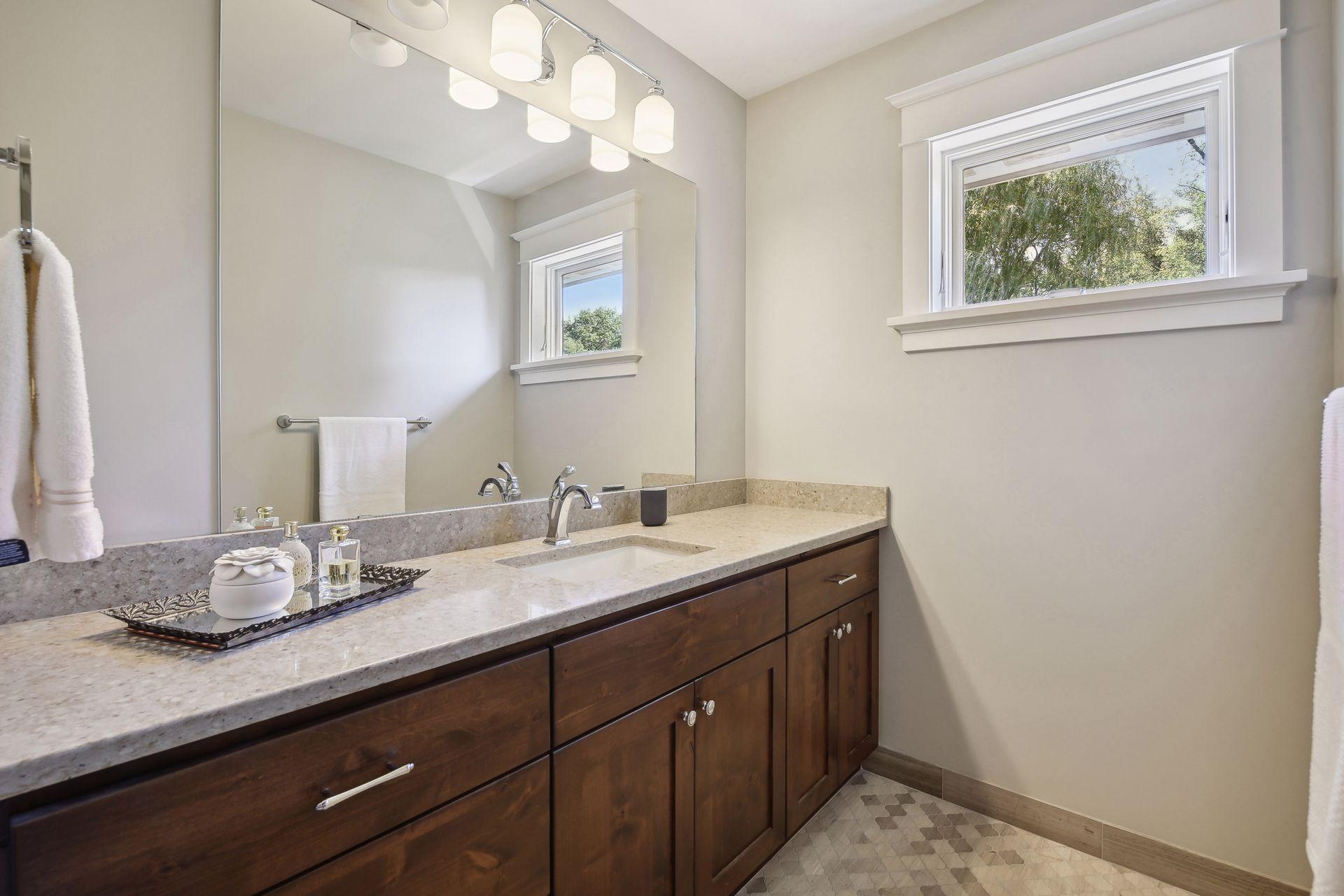 Jack and jill bathroom with private vanities for both bedrooms