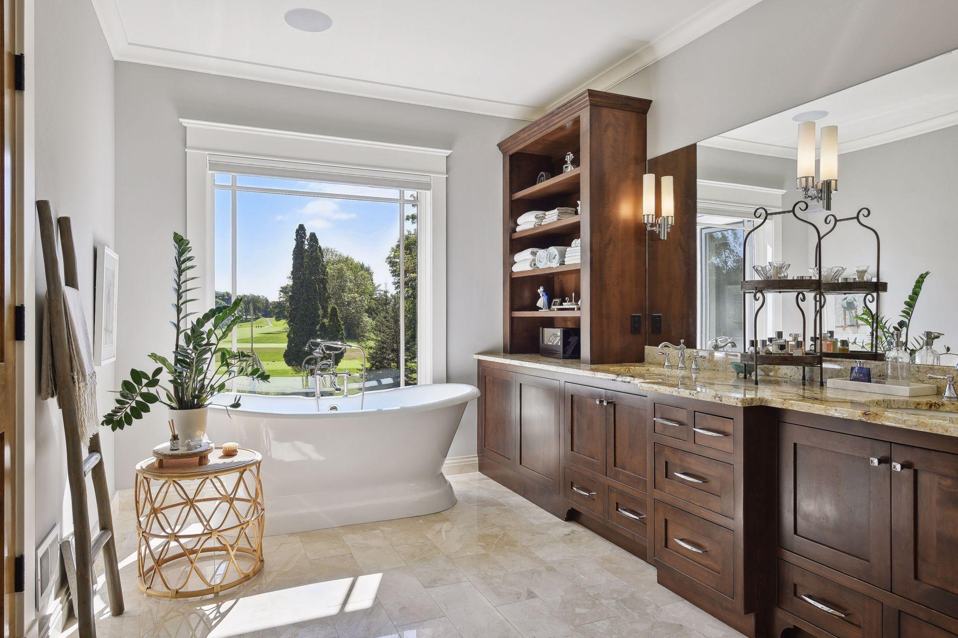 Main floor primary private full bathroom with heated floors, free standing Barclay soaking tub, electronic blinds