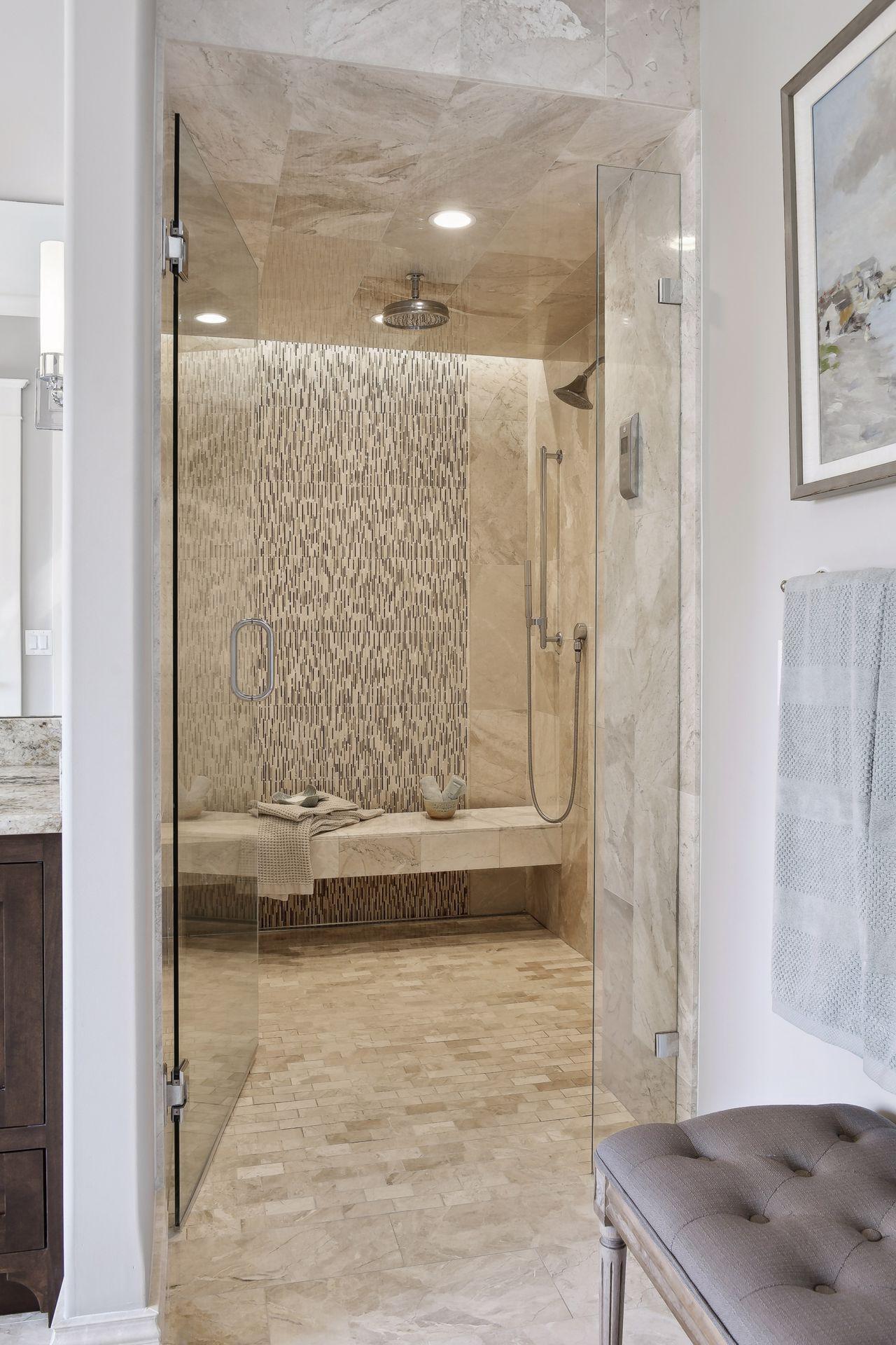 Large shower with French trough drain, floarting bench, accent lighting and Kohler electronic temperature control,