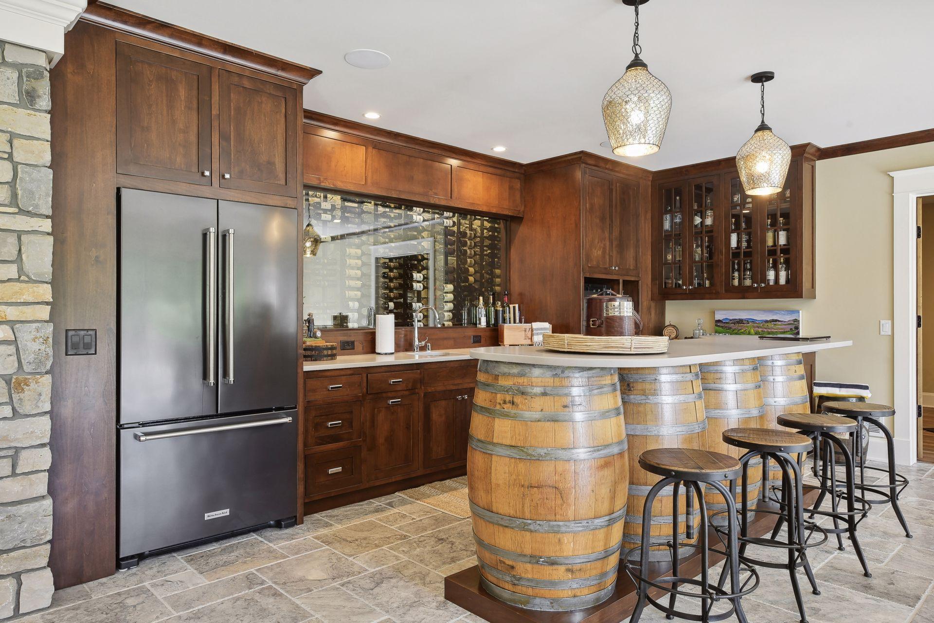 Wet bar with 4 barrel bar, full refrigerator, built-in cabinetry and dishwasher