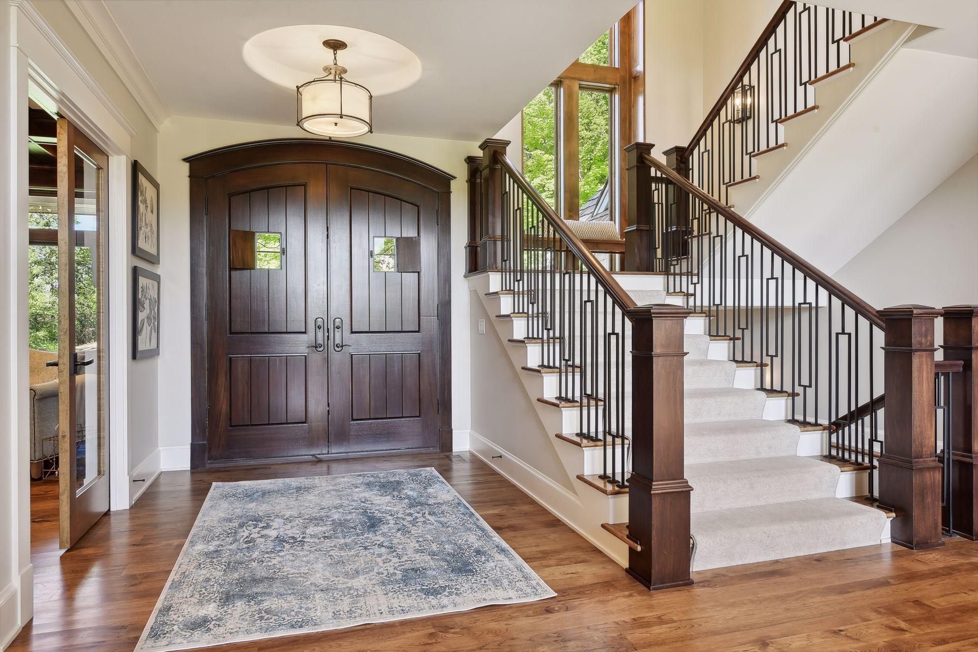 Hickory hardwood floors on main level and stairs. Extra wide staircase with iron railings