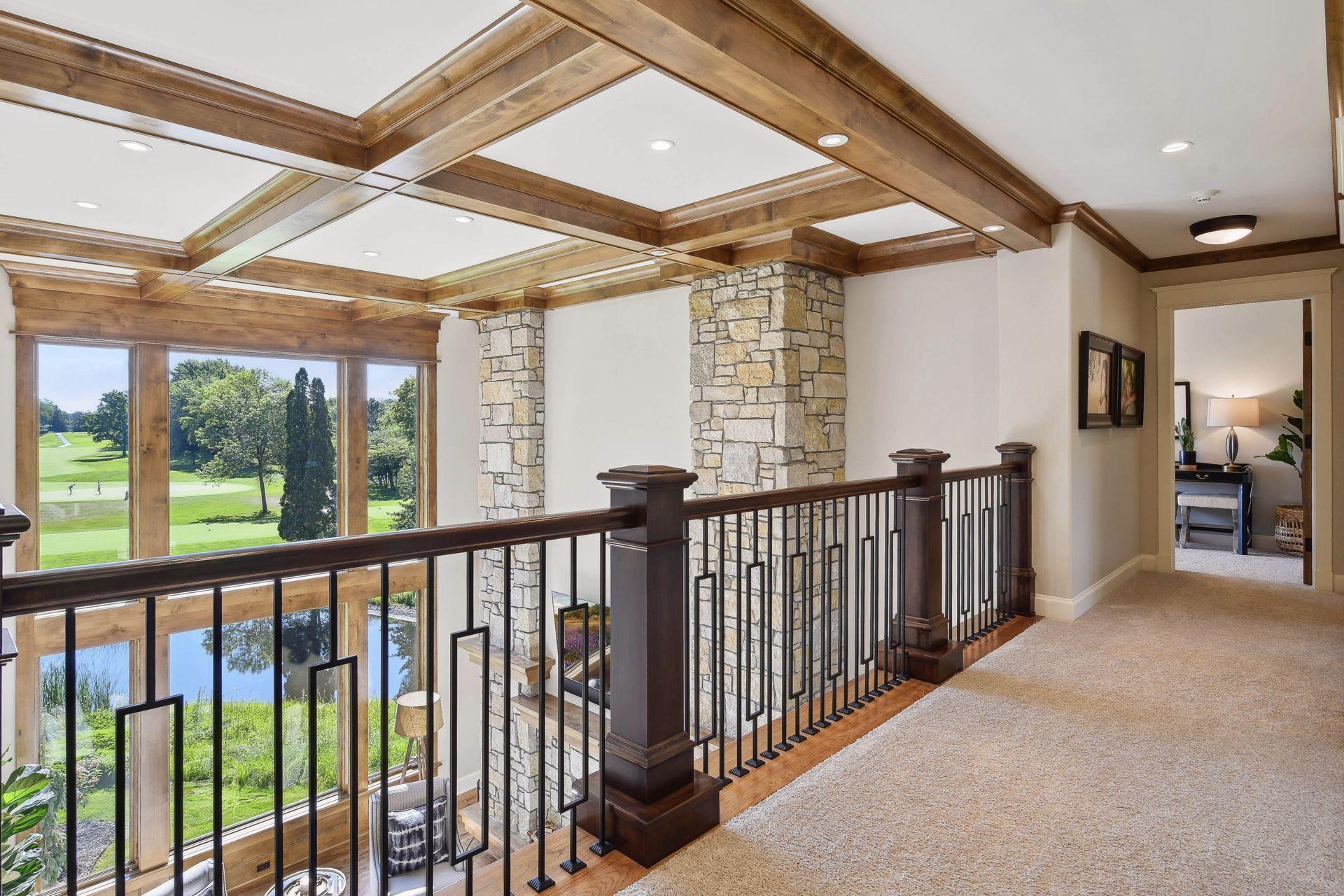 2nd level catwalk balcony overlooking main floor great room with expansive views of golf course