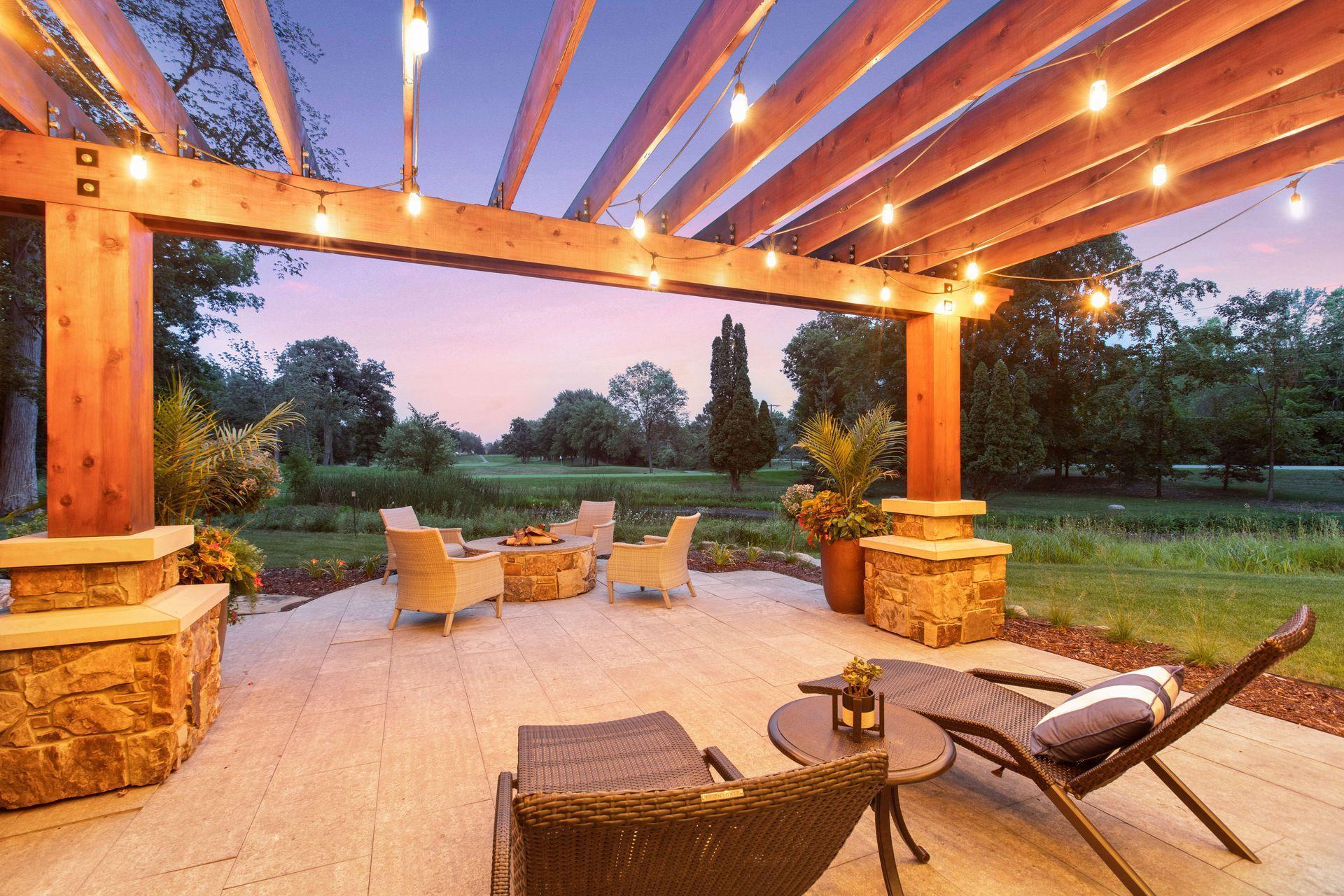 Four panel sliding patio doors leads to patio terrace with natural gas firepit, pergola lighting system and outdoor speakers.