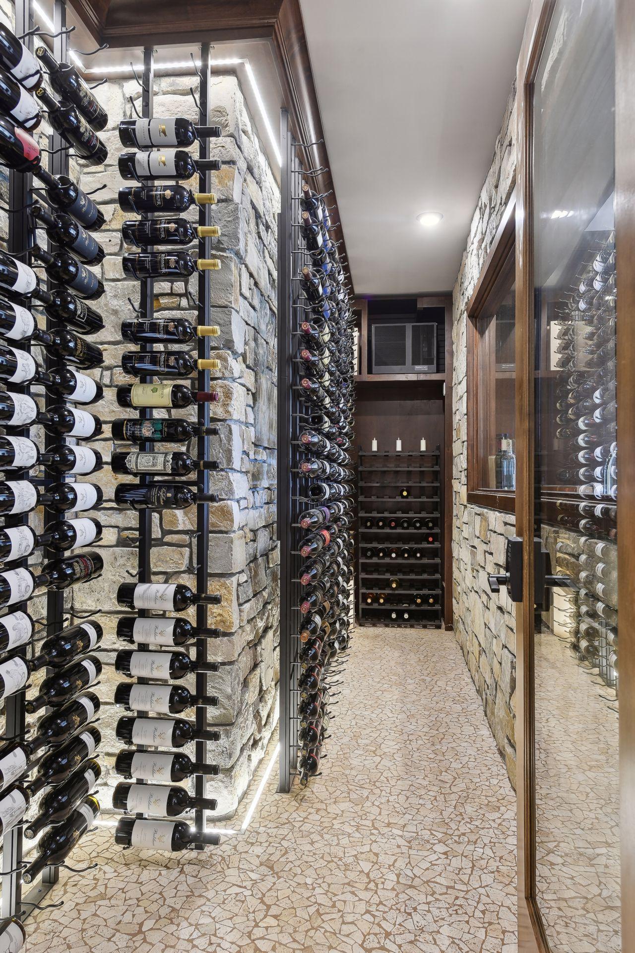 Wine cellar with stone walls, ambient lighting and upgraded quiet split system cooling unit