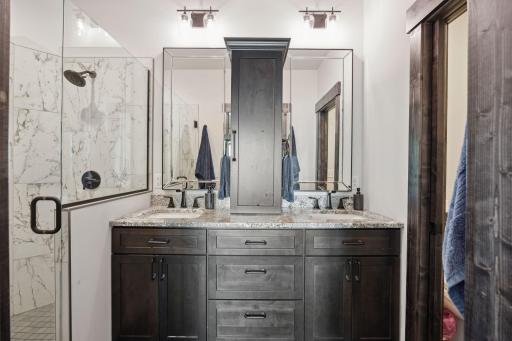Luxurius primary bath with double sinks, separate toilet & step-in shower.