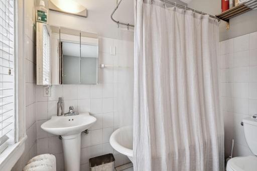 Bathroom has a fun bathtub with claw feet.