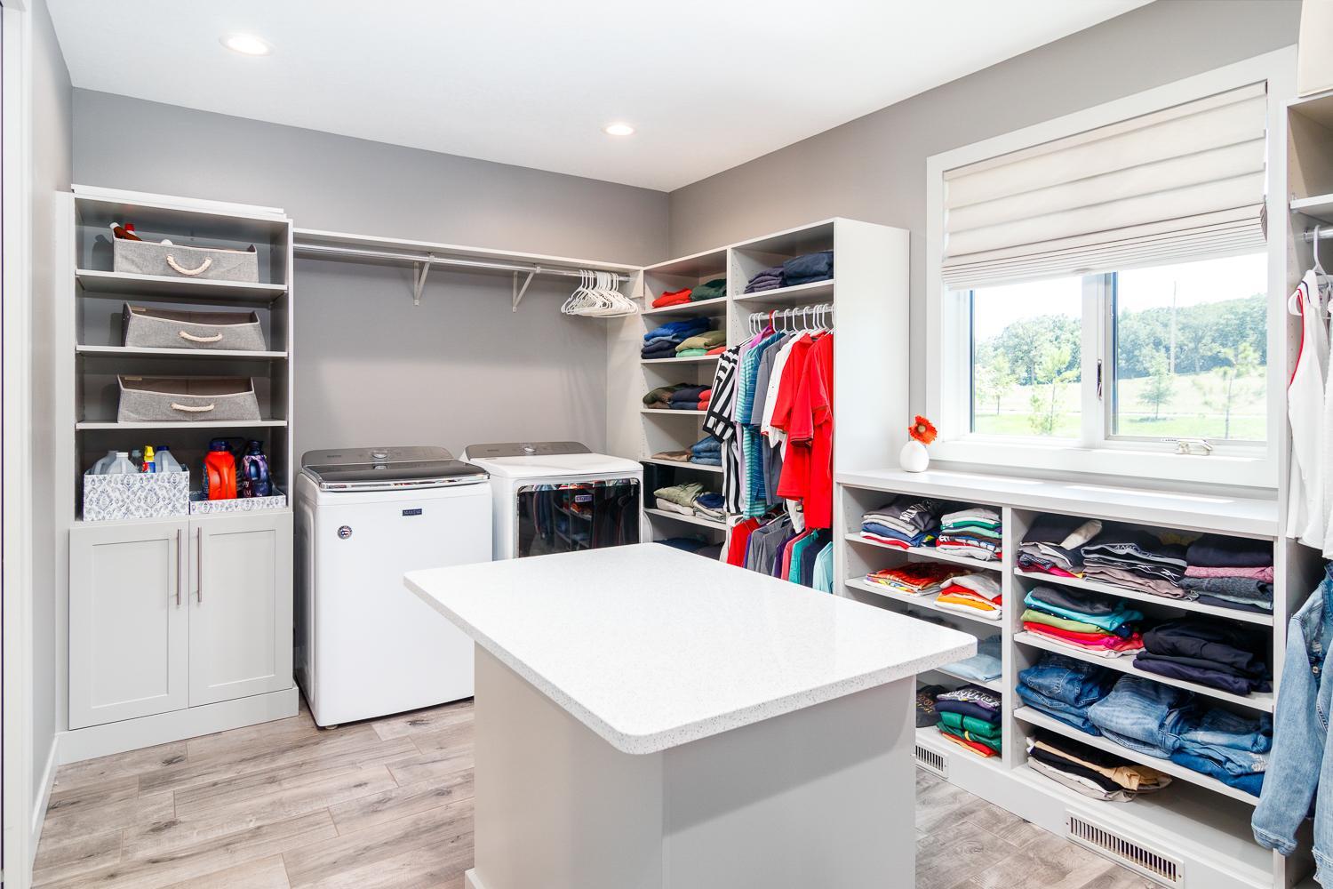 Primary walk in closet with laundry
