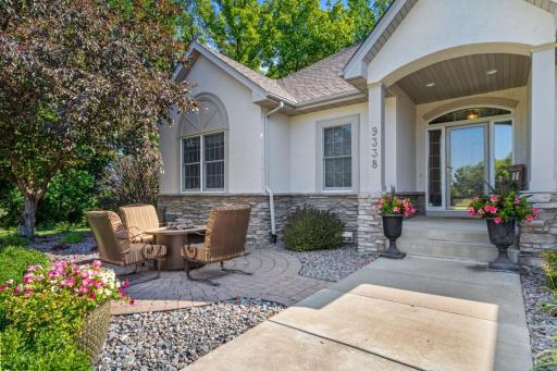 Front brick patio area and fire pit. Fountain included and stays with home.