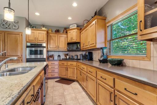 Custom kitchen with maple cabinets,granite countertop, ceramic floors, and stainless appliances.