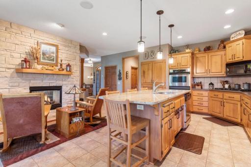 Kitchen flows into hearth area with gas fireplace.
