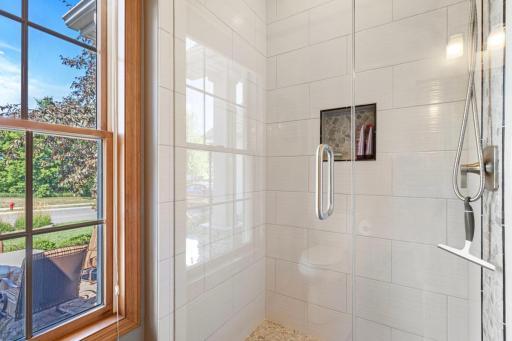 Three quaters bath has tiled floors and shower.