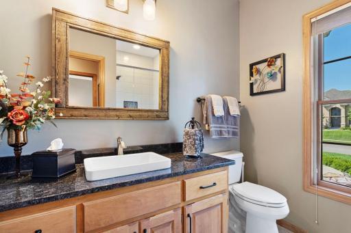 Three quarter upstairs bath with granite counter.