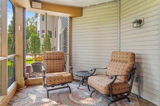Fully enclosed screened porch with roof and gutters for water run off.