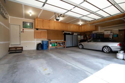 3 car garage. Work bench and cabinets staying. Additional storage above the garage doors.
