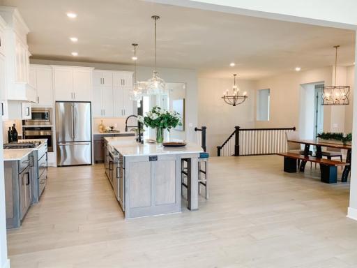 Photo from a similar home in another community. Cabinets will go to the ceiling, appliances and colors will vary.