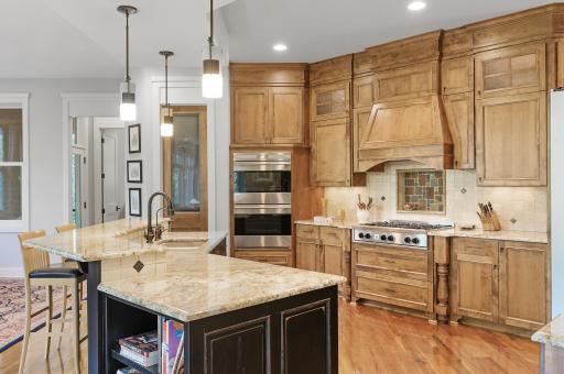 Other kitchen details include sparkling granite countertops, breakfast bar seating, and more.