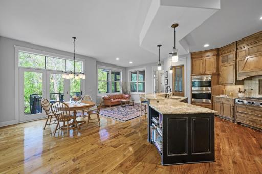 Adjoining sitting area and dining space - all with a view of the private wooded backyard.