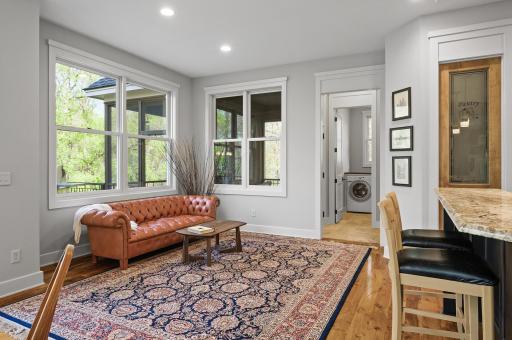Cozy lounge off the kitchen and leads into the lovely screened porch.