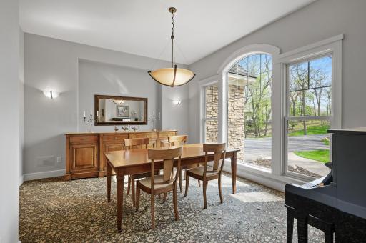 Spacious formal dining has plenty of space for a large table and big gatherings, or entertaining. Beautiful floor to ceiling arched window.