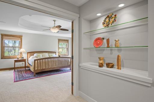 Double solid wood doors and inset glass shelving welcome your to your dream suite!