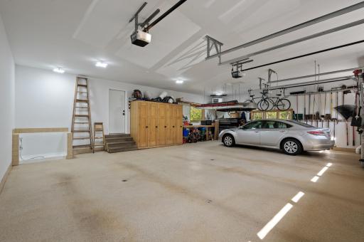 View of the attached heated 3-car garage. There is ALSO a tuck-under three-car garage perfect for a workshop or toys! Tons of additional driveway parking space as well if you have an RV or trailer.