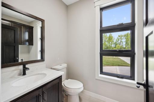Half bath shared with laundry, located as you enter through the garage.