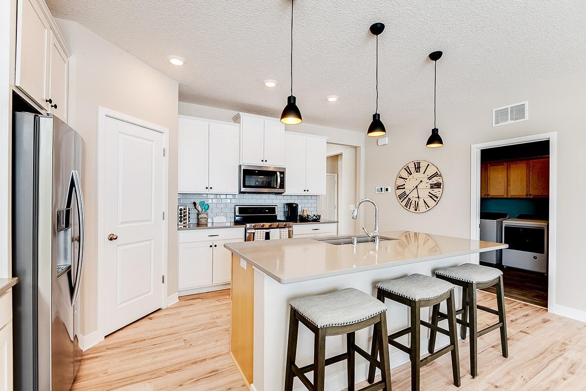 Thoughtfully designed kitchen with ample counter space and gas appliances. Staged model photos. See listing agent for home specific selections.