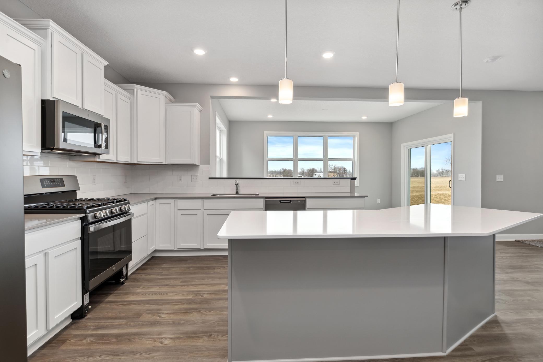 Enlarged kitchen island. Peace of mind with low maintenance quartz countertops! Colors and options may vary.