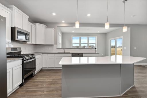 Enlarged kitchen island. Peace of mind with low maintenance quartz countertops! Colors and options may vary.