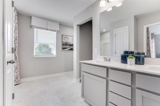 Light and bright primary bathroom. Raised vanity gives you extra storage!