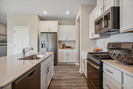 Picture of a model home with the same floorplan and similar features.