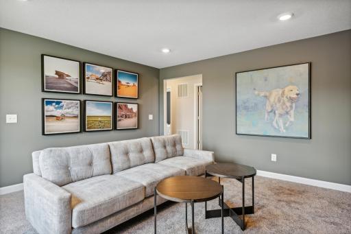 Picture of a model home with the same floorplan and similar features.