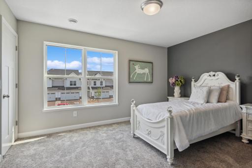 Picture of a model home with the same floorplan and similar features.