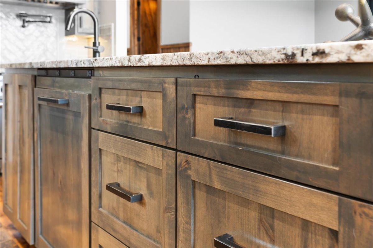 The Knotty Alder Cabinets were furnished with Custom Handmade hardware. You will find this hardware throughout the home.