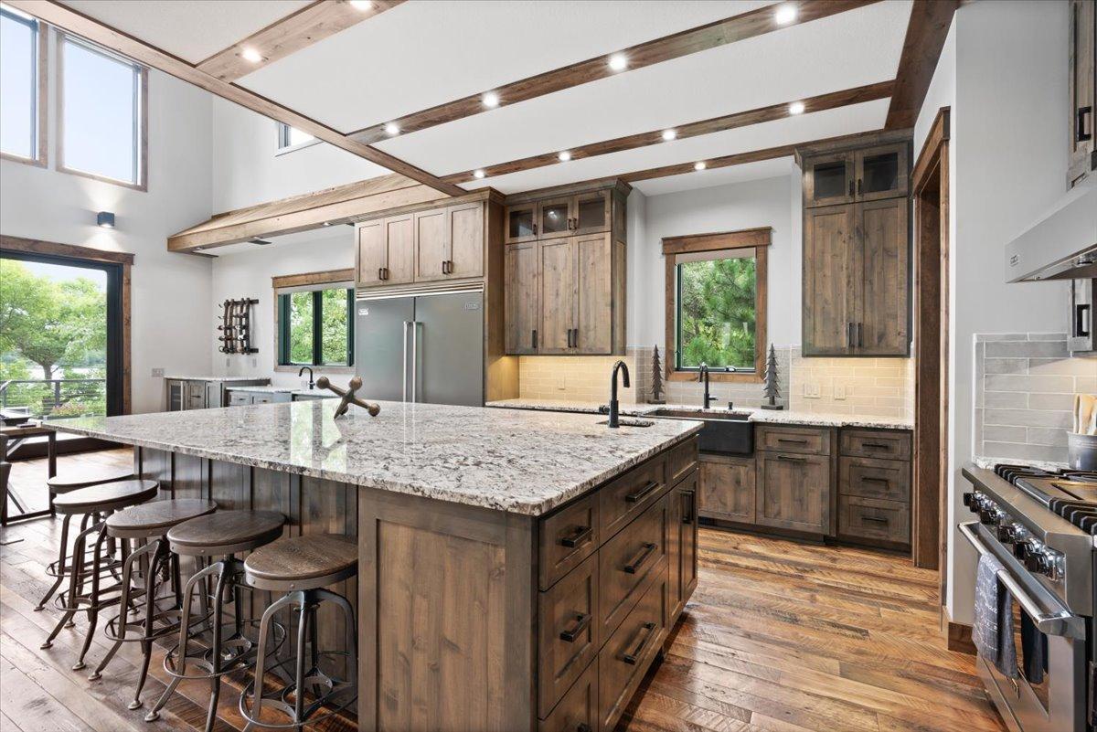 Tall Custom Knotty Alder Cabinets are built in throughout the kitchen and wet bar.
