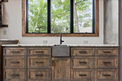 Wet bar near the main living room features a Viking beverage fridge, ice maker, sink and several cabinets/drawers for storage.