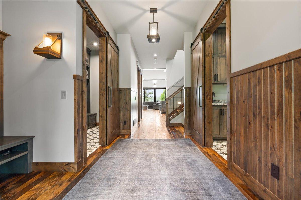 8' doors throughout the main level. The Foyer leaves access to the main home, mud room with built in lockers and heated floors or the main level laundry room.