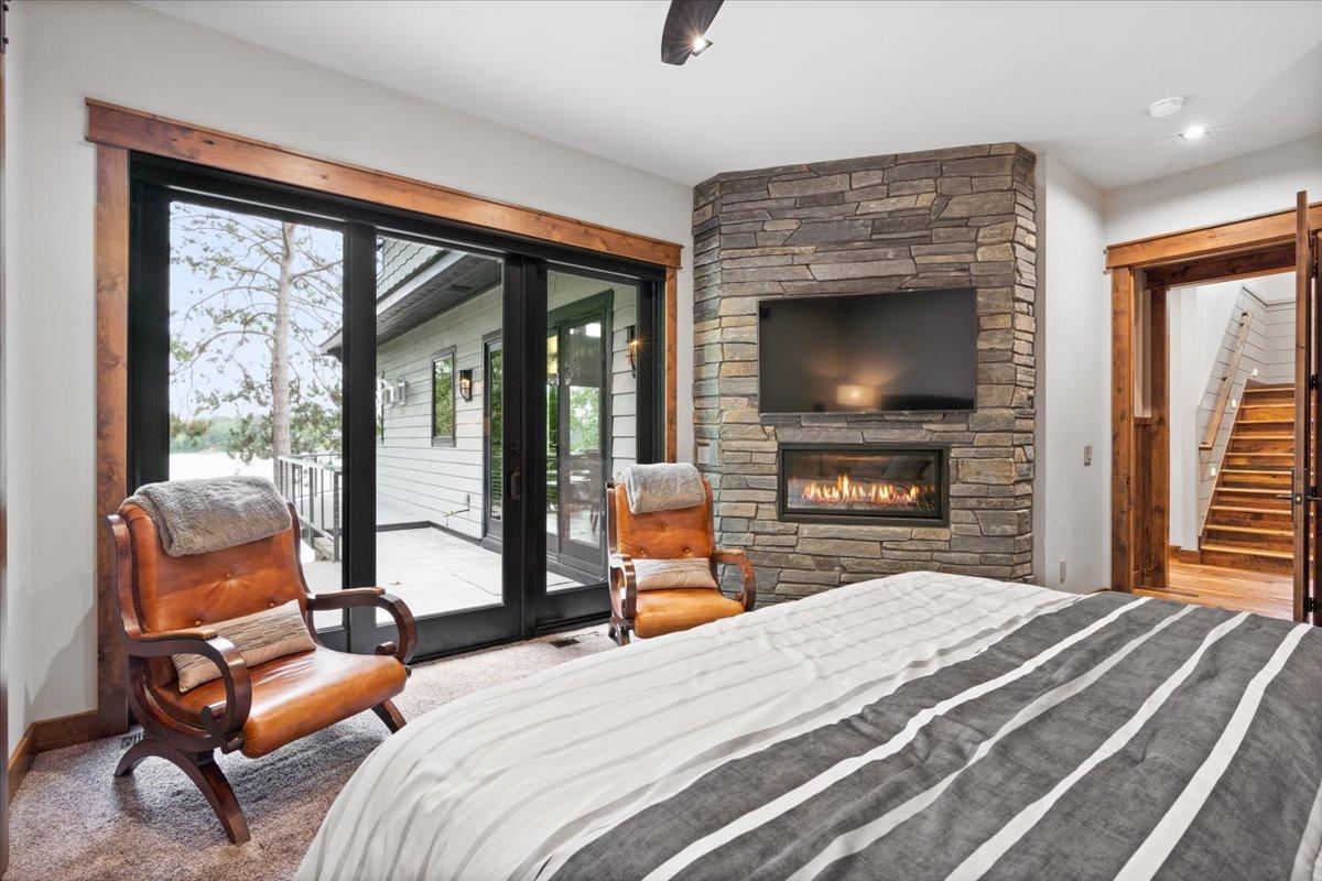 Walk-out to the main level patio from the Master Bedroom! Also home to a 36" Lineal Fireplace.