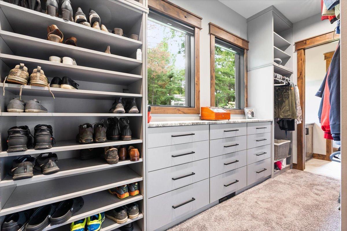 Built in drawers and shoe racks throughout the Master Walk-In Closet.