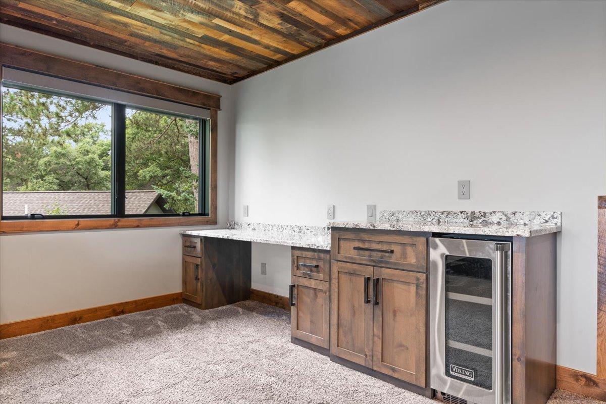 Computer desk and Viking beverage fridge in the upper level loft.