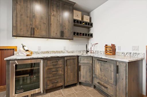 Basement wet bar with Viking beverage fridge, ice maker and dish washer!