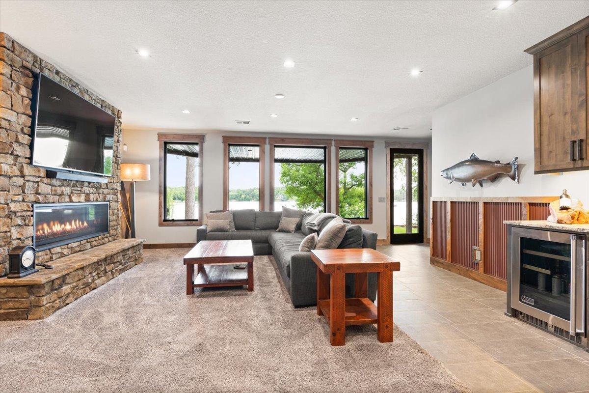 Lower Level Family Room w/wet bar, fireplace and incredible lake view.