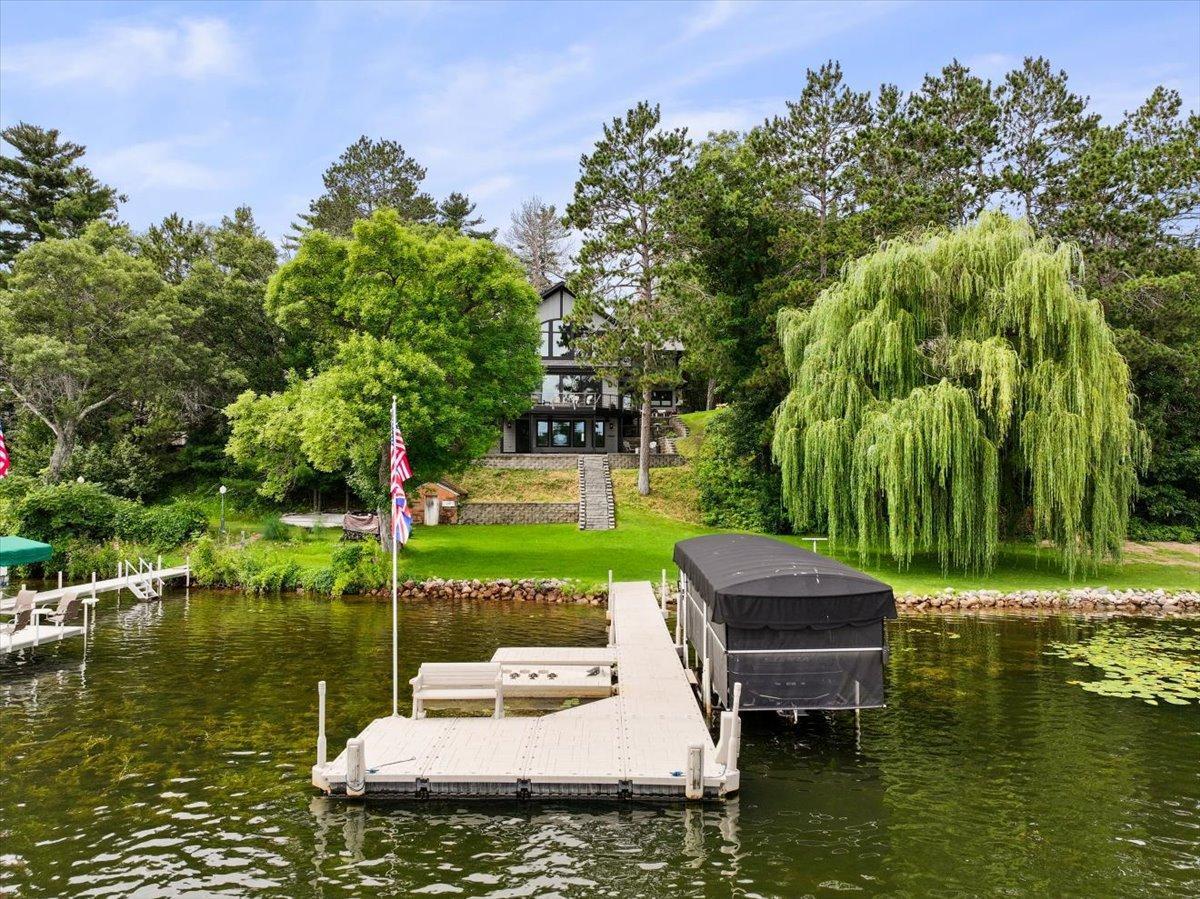 With 182 feet of lake frontage, 2 boat house, and a nice level landing by the lake, you will have easy access to the water with room for lake side recreation.