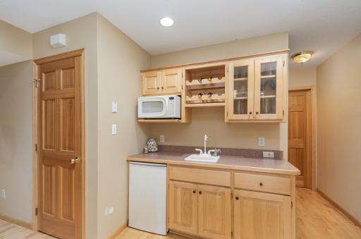 Lower level has walk up wetbar with microwave and beverage fridge. There is also an additional full size fridge.