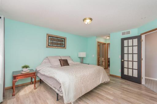 Primary bedroom has two closets leading to bathroom