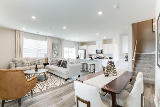 Main level offers open concept living showcasing larger windows for natural light and low maintenance flooring throughout entire main level for a cohesive look and feel.