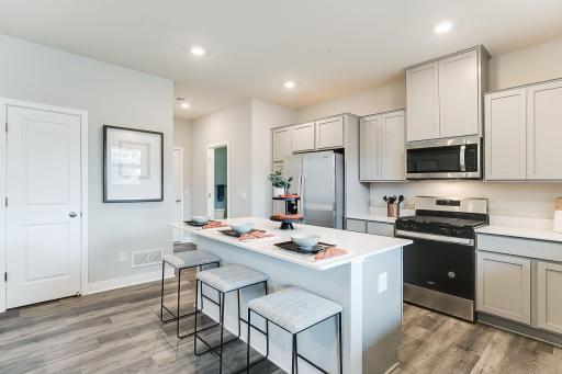 The Fairmont's kitchen offers a spacious center island for your entertaining and culinary needs. It is both functional and beautiful with the luxurious quartz countertops!