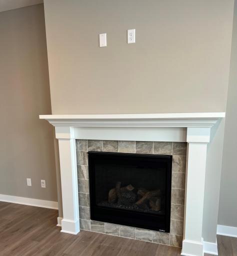 Centered fireplace with tile surround. Tile color will be different. Esplanade - Alley Polished. *Please note, photos are of a similar model home, features and colors in actual home will vary. Please contact listing agent for exact specifications.